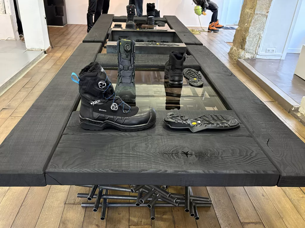 JALAS safety boots and Vibram Arctic Grip Pro outsoles displayed on a central table at Vibram’s Extreme Works installation
